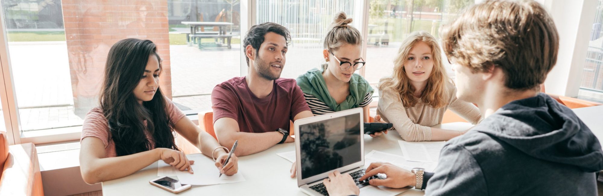 homepage_hero_3 Group of sUConn MSW social work students studying at a table.