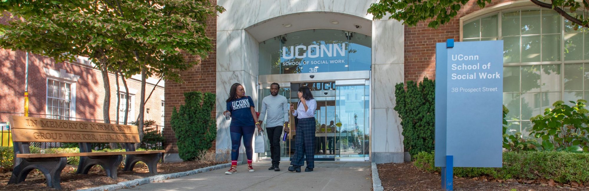 homepage_hero_4 Three UConn Social Work students walking out of the building.